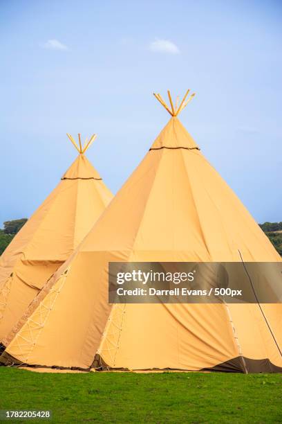 scenic view of tent on field against sky - teepee stock pictures, royalty-free photos & images