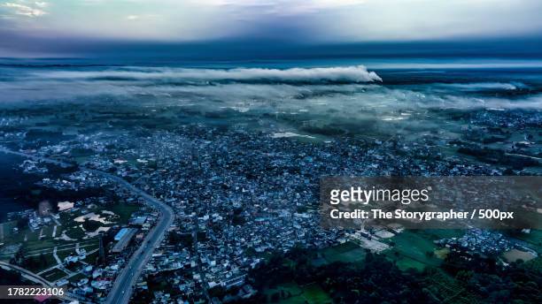 aerial view of city by sea against sky - the storygrapher fotografías e imágenes de stock