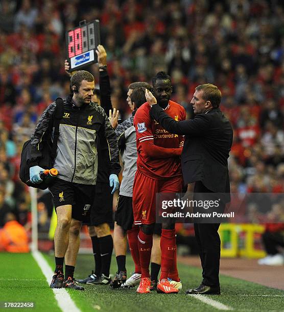 Aly Cissokho of Liverpool is spoken to by manager Brendan Rodgers as he is substituted off the pitch after suffering an injury during the Capital One...