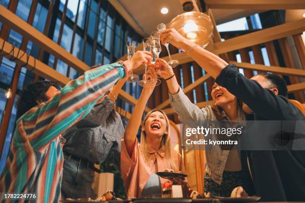 asian group of business poeple celebratory toast - new year's eve dinner stock pictures, royalty-free photos & images