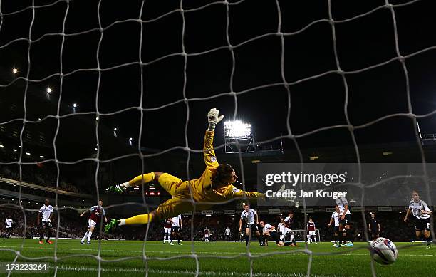 Ravel Morrison of West Ham United shoots past goalkeeper Scott Brown of Cheltenham Town to score their second goal during the Capital One Cup second...