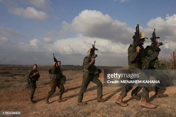 Israeli army soldiers return after searching for human remains following the October 7 attack carried out by Palestinian militants from the Gaza...