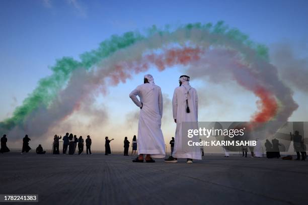 The Italian Air Force aerobatic unit Frecce Tricolori spread smoke with the colors of the Italian flag as they fly over Dubai during the Gulf...
