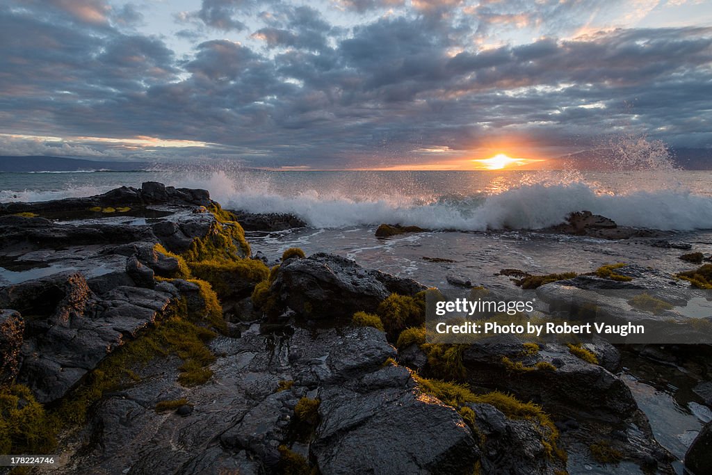 Waves crashing onto Rocks at Sunset