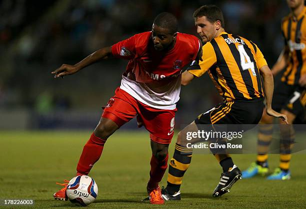 Kevin Lisbie of Leyton Orient is challenged by Alex Bruce of Hull City during the Capital One cup second round match between Leyton Orient and Hull...