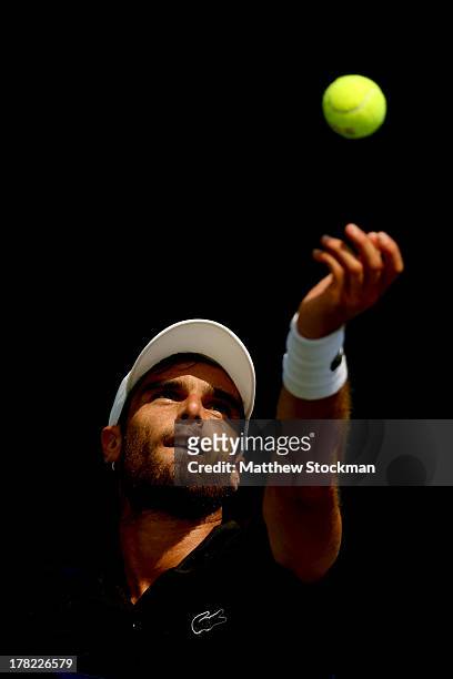 Pablo Andujar of Spain tosses the ball in the air to serve during his men's singles first round match against Thiemo De Bakker of Netherlands on Day...