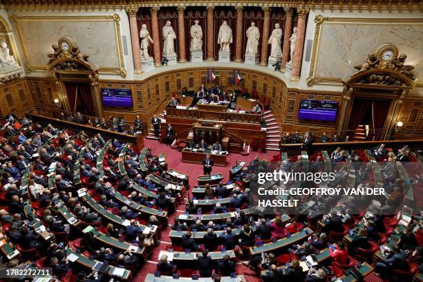 French Interior Minister Gerald Darmanin addresses the Senate during a voting session on an immigration bill at the French Senate in Paris on...