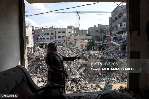 Palestinian woman gestures as she explains how her home was destroyed duing the Israeli bombardment, in Bureij in the central of Gaza Strip, on...