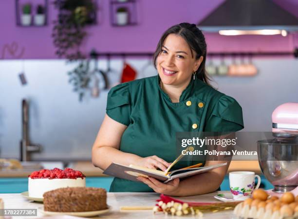 happy baker looking at the camera - cookbook stock pictures, royalty-free photos & images