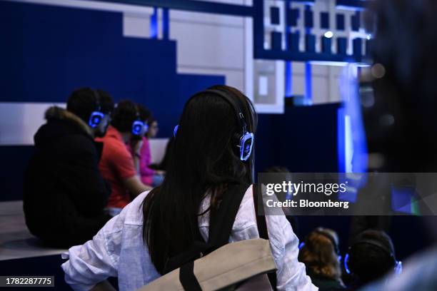 Attendees wear illuminated headphones on the opening day of the Web Summit in Lisbon, Portugal, on Tuesday, Nov. 14, 2023. Many investors pulled out...