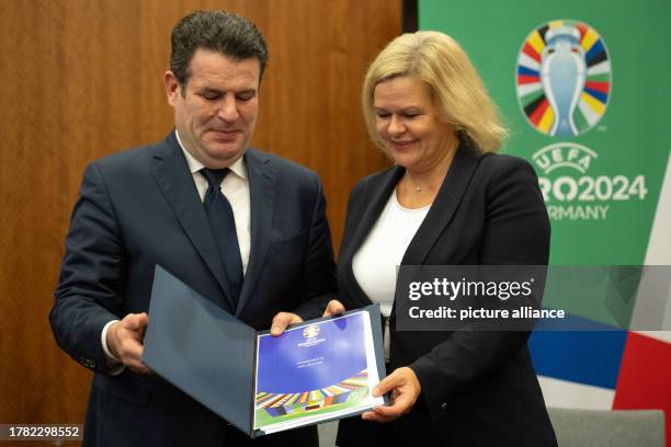 November 2023, Berlín: German Labor Minister Hubertus Heil and Interior Minister Nancy Faeser show the declaration committing Euro 2024 in Germany to...