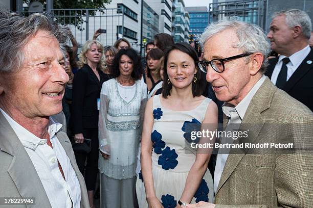 Director Woody Allen , his wife Soon-Yi Previn and director Roman Polanski share a light moment as they arrive to the Paris premiere of "Blue...