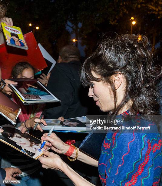 Actress Sally Hawkins signs autographs for fans as she arrives to the Paris premiere of "Blue Jasmine" at UGC Cine Cite Bercy on August 27, 2013 in...