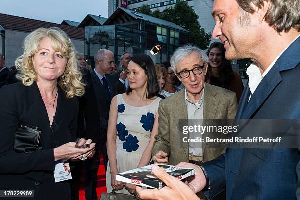 Director Woody Allen signs an autograph to Stephane Celerier, CEO of Mars Distribution as Allen's wife Soon-Yi Previn looks on, as they arrive to the...