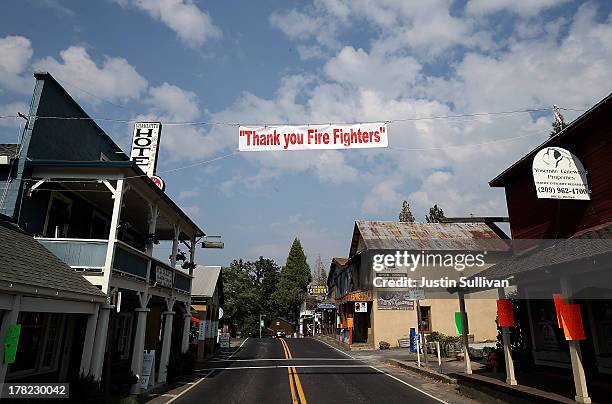 Sign thanking firefighters hangs over an empty highway 120 on August 27, 2013 in Groveland, California. As the Rim Fire continues to burn in and...