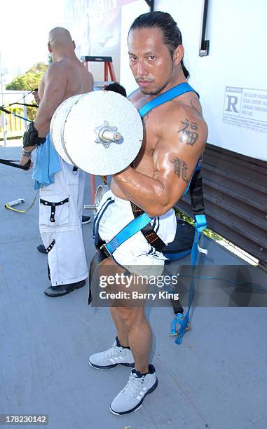 Live body builders work out on a billboard over Sunset Boulevard celebrating the Blu-Ray/DVD release of 'Pain & Gain' on August 27, 2013 in West...