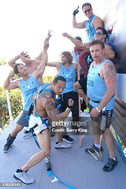 Live body builders work out on a billboard over Sunset Boulevard celebrating the Blu-Ray/DVD release of 'Pain & Gain' on August 27, 2013 in West...