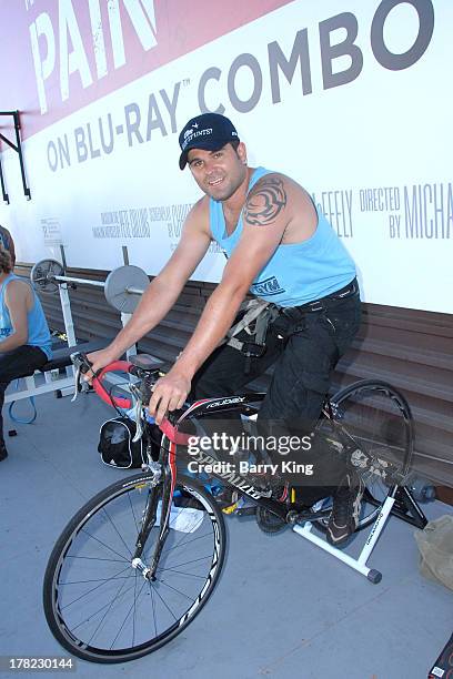 Live body builders work out on a billboard over Sunset Boulevard celebrating the Blu-Ray/DVD release of 'Pain & Gain' on August 27, 2013 in West...