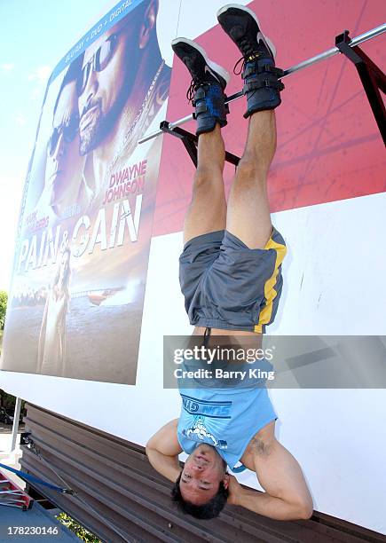 Live body builders work out on a billboard over Sunset Boulevard celebrating the Blu-Ray/DVD release of 'Pain & Gain' on August 27, 2013 in West...