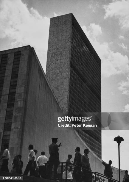 Security guard and pedestrians outside the visitors' entrance of the United Nations headquarters in Midtown Manhattan, New York City, New York, circa...