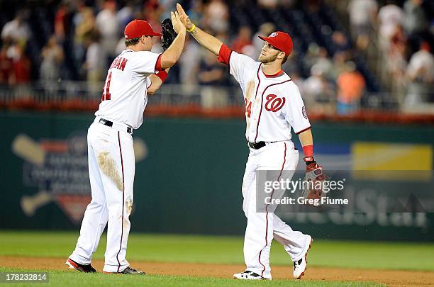 Bryce Harper of the Washington Nationals celebrates with Ryan Zimmerman after a 2-1 victory against the Miami Marlins at Nationals Park on August 27,...