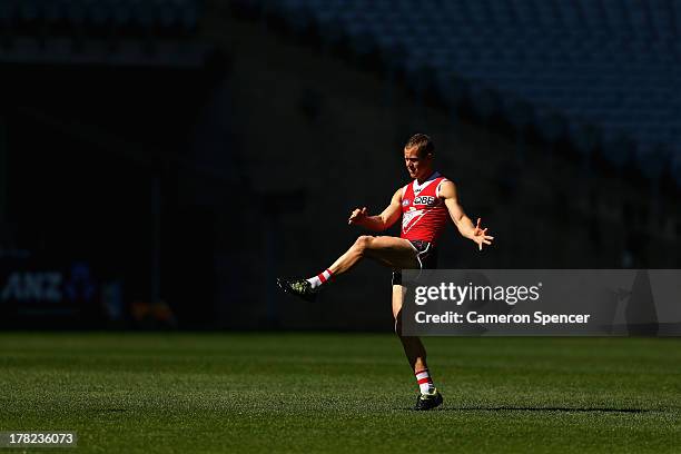 Ryan O'Keefe of the Swans kicks during a Sydney Swans AFL training session at ANZ Stadium on August 28, 2013 in Sydney, Australia.