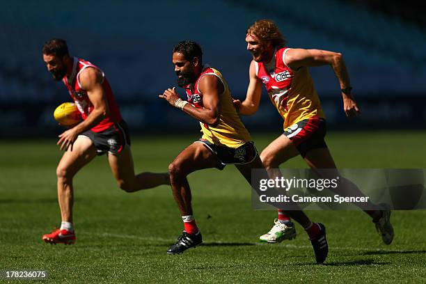 Lewis Jetta of the Swans and team mates run during a Sydney Swans AFL training session at ANZ Stadium on August 28, 2013 in Sydney, Australia.