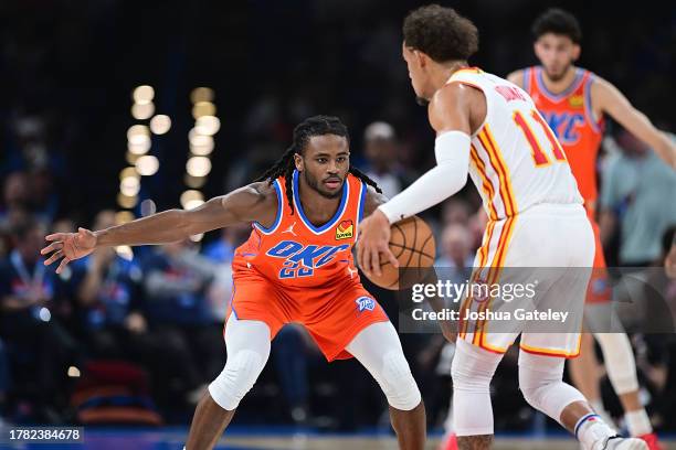 Cason Wallace of the Oklahoma City Thunder looks to defend Trae Young of the Atlanta Hawks during the first half at Paycom Center on November 6, 2023...