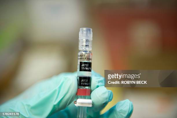 Nurse loads a syringe with a vaccine against hepatitis at a free immunization clinic for students before the start of the school year, in Lynwood,...