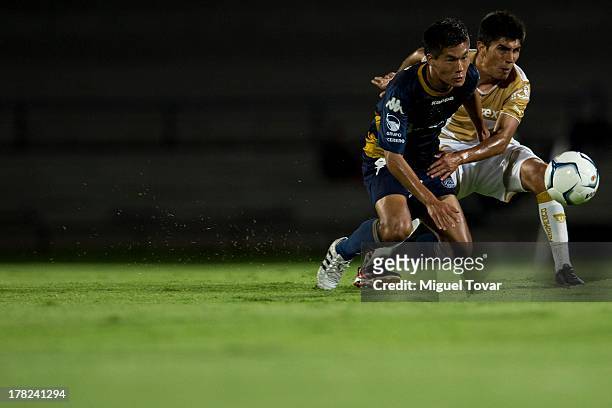 Antonio Garcia of Pumas struggles for the ball with Kenyi Adachi of Atletico San Luis during a match between Pumas and Atletico San Luis as part of...