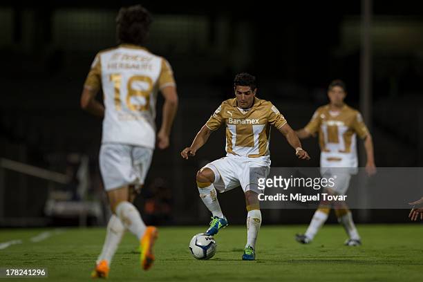 Martin Bravo of Pumas drives the ball during a match between Pumas and Atletico San Luis as part of the Apertura 2013 Copa MX at Olympic Stadium on...