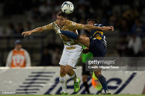 Efrain Velarde of Pumas struggles for the ball with Kenyi Adachi of Atletico San Luis during a match between Pumas and Atletico San Luis as part of...
