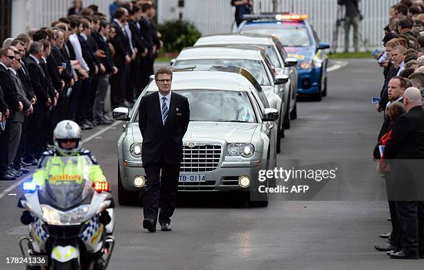 Mourners line the street outside the St Therese's Parish for the funeral of Australian baseball player Chris Lane, who was killed in the small...