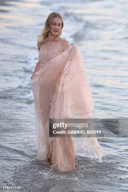 Italian model Eva Riccobono poses during a photocall at the Excelsior beach on the eve of the opening ceremony of the 70th Venice Film Festival on...