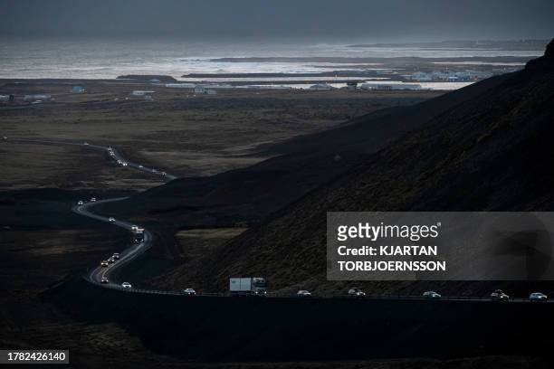 This photo taken on November 13, 2023 shows vehicles leaving the town of Grindavik, southwestern Iceland, during evacuation following earthquakes....