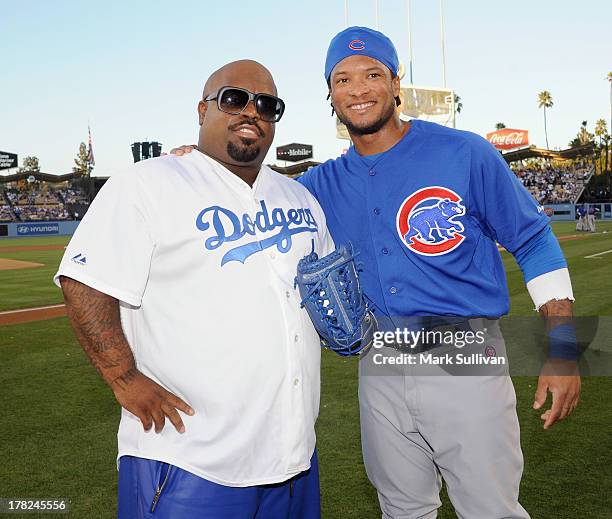 CeeLo Green and Chicago Cub outfielder Darnell McDonald on the field before throwing out the ceremonial first pitch before the MLB game between the...