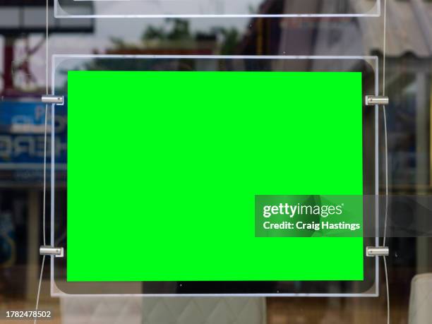advert marketing sign. green screen display in shop window similar to real estate signs - schaufenster stock-fotos und bilder