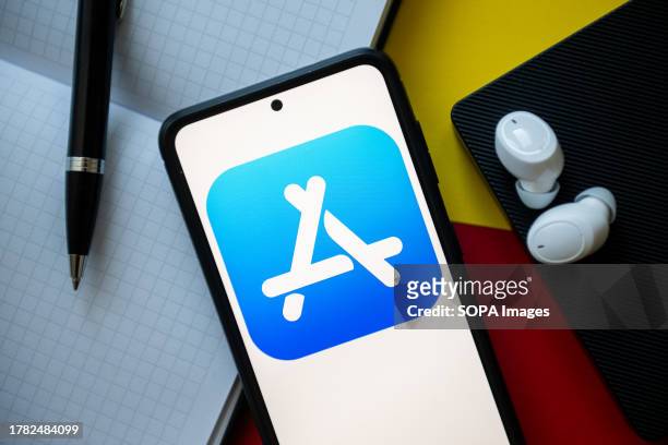 In this photo illustration a Apple app store logo seen displayed on a smartphone.