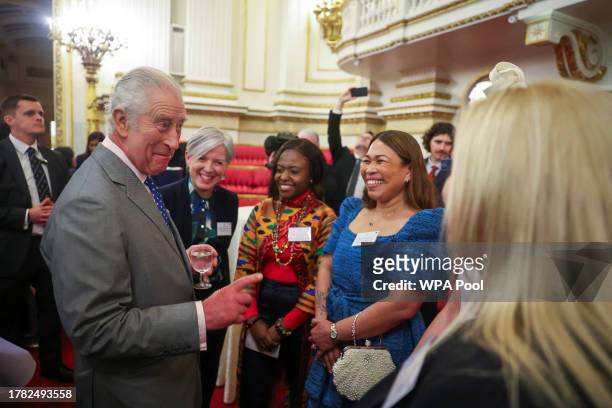 King Charles III meets guests as he hosts a reception to celebrate UK nurses and midwives at Buckingham Palace on November 14, 2023 in London,...