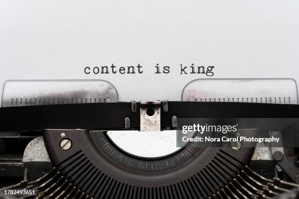 content is king typed on a typewriter - schreibmaschine stock-fotos und bilder