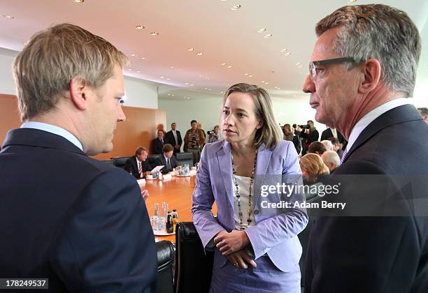 German Health Minister Daniel Bahr, German Family Minister Kristina Schroeder, and German Defense Minister Thomas de Maiziere arrive for the weekly...