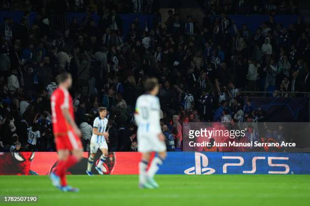 Flare is thrown to Real Sociedad fans in the stands during the UEFA Champions League match between Real Sociedad and SL Benfica at Reale Arena on...