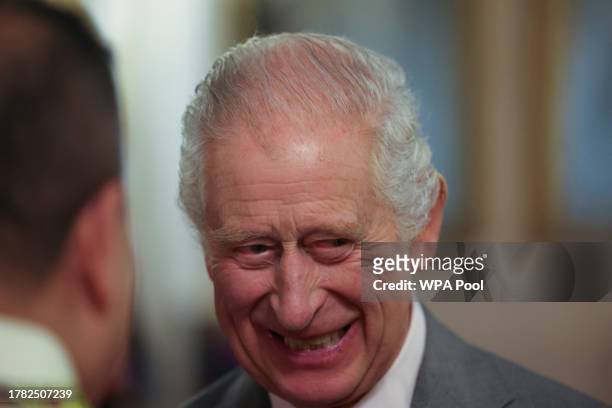 King Charles III smiles as he hosts a reception to celebrate UK nurses and midwives at Buckingham Palace on November 14, 2023 in London, England.