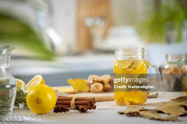 ginger and lemon infused water in a mason jar on kitchen counter - honey lemon stock pictures, royalty-free photos & images