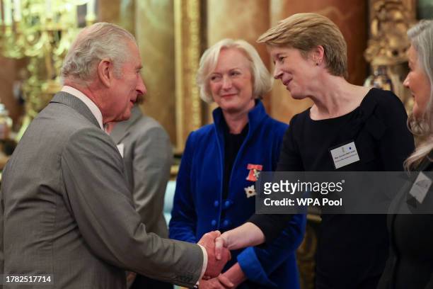 Britain's King Charles III greets Chief Nursing Officer for England Ruth May and Chief Executive Officer of NHS England Amanda Pritchard as he meets...