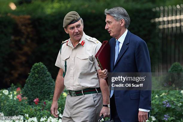 British Defense Secretary Philip Hammond arrives in Downing Street with the Chief of the Defense Staff, General Sir Nick Houghton, on August 28, 2013...