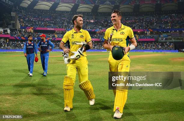 Glenn Maxwell of Australia celebrates with team mate Pat Cummins after hitting a six for the winning runs, finishing unbeaten on 201 not out during...