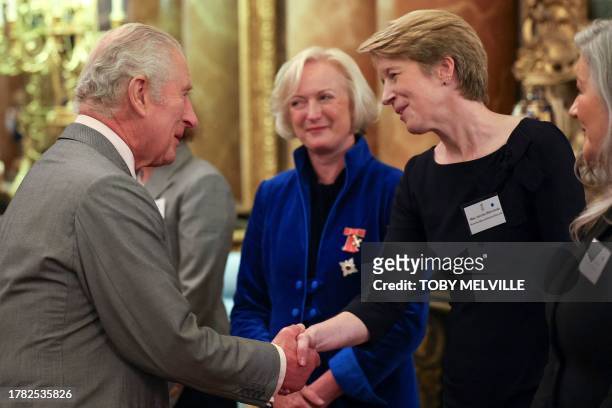 Britain's King Charles III greets Chief Nursing Officer for England Ruth May and CEO of NHS England Amanda Pritchard, during a reception to celebrate...