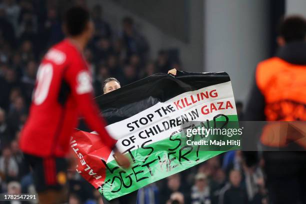 Pitch invader holds the Palestinian flag during the UEFA Champions League match between F.C. Copenhagen and Manchester United at Parken Stadium on...