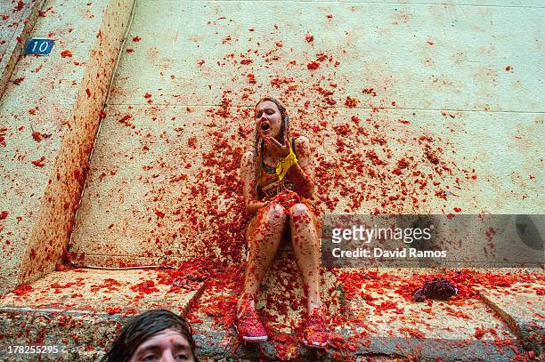 Revellers celebrate covered by tomato pulp while participating the annual Tomatina festival on August 28, 2013 in Bunol, Spain. An estimated 20,000...
